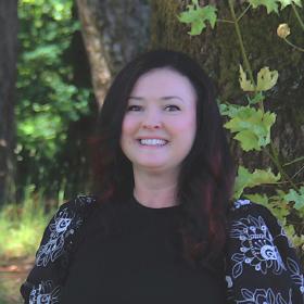 A woman in a black shirt smiling